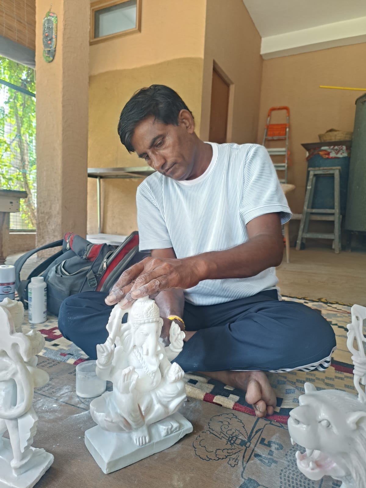 Artisan finishing a religious sculpture